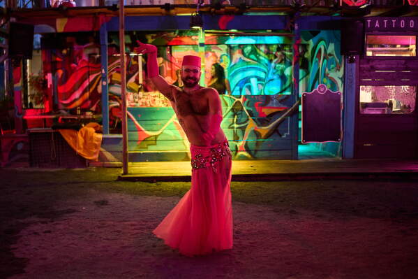 Haidar Darwish, a Syrian belly dancer with the Berlin-based LGBTQ collective Queens Against Borders, performs during an open-air show in Berlin, Germany, Friday, July 17, 2026. (AP Photo/Ebrahim Noroozi)