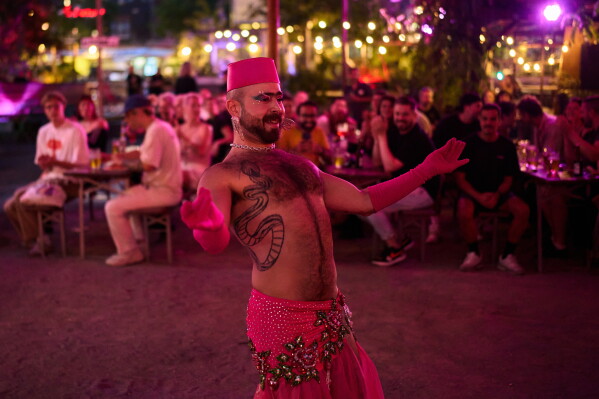 Haidar Darwish, a Syrian belly dancer with the Berlin-based LGBTQ collective Queens Against Borders, performs during an open-air show in Berlin, Germany, Friday, July 17, 2026. (AP Photo/Ebrahim Noroozi)