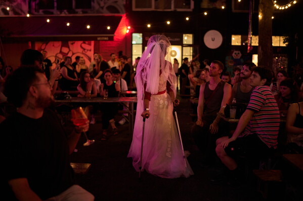 Kekik a member of the Berlin-based LGBTQ collective Queens Against Borders, performs during an open-air show in Berlin, Germany, Friday, July 17, 2026. (AP Photo/Ebrahim Noroozi)