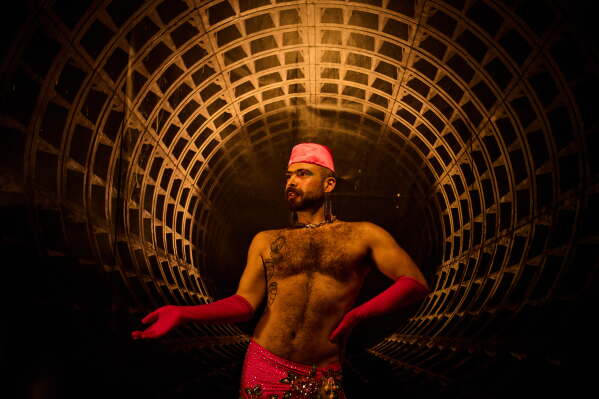 Haidar Darwish, a Syrian belly dancer with the Berlin-based LGBTQ collective Queens Against Borders, prepares backstage before an open-air show in Berlin, Germany, Friday, July 17, 2026. (AP Photo/Ebrahim Noroozi)