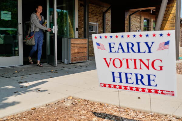 A voter walks out after voting at a polling place, Tuesday, July 28, 2026, in Milwaukee. (AP Photo/Nam Y. Huh)