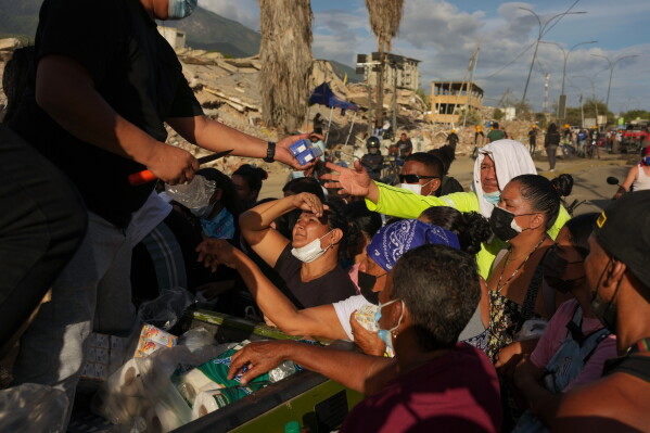 People affected by the earthquakes line up for food in La Guaira, Venezuela, June 28, 2026. (AP Photo/Matias Delacroix, File)