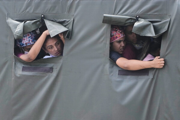 Health workers ride in a truck on their way to join earthquake relief efforts in La Guaira, Venezuela, June 28, 2026. (AP Photo/Fernando Vergara, File)
