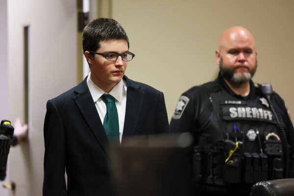 Colt Gray, the 16-year-old Apalachee High School shooting suspect, is led in by deputies for his sentencing at Barrow County Superior Court, Monday, July 27, 2026, in Winder, Ga. (Jason Getz/Atlanta Journal-Constitution via AP, Pool)