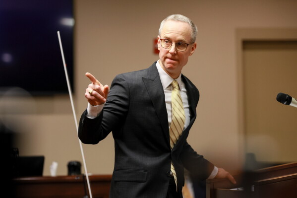 District Attorney Brad Smith points to the defendant Colin Gray, the father of Apalachee High School shooting suspect Colt Gray, during Smith's opening statements in the courtroom at the Barrow County courthouse, Feb. 16, 2026, in Winder, Ga. (Jason Getz/Atlanta Journal-Constitution via AP, File)