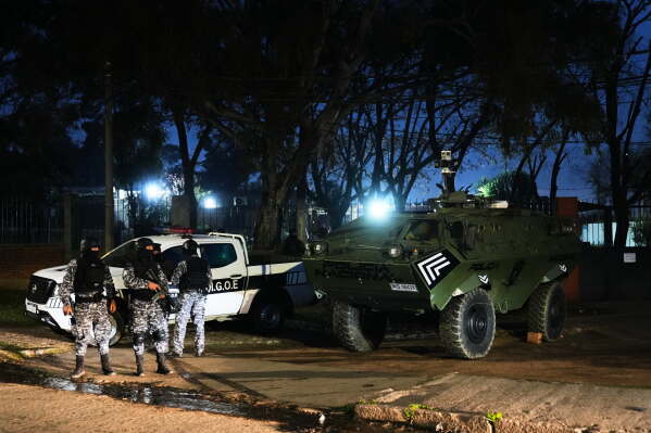 Police patrol by a U.S. donated Mamba armored military vehicle in the Marconi neighborhood of Montevideo, Uruguay, Sunday, July 26, 2026. (AP Photo/Matilde Campodonico)