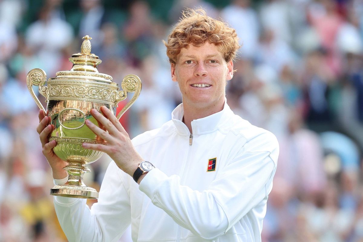 Jannik Sinner holding the winner's trophy at Wimbledon 2025