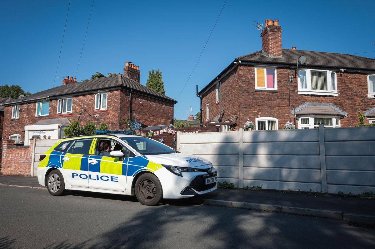 Police attend the scene on Ivylea road, Burnage