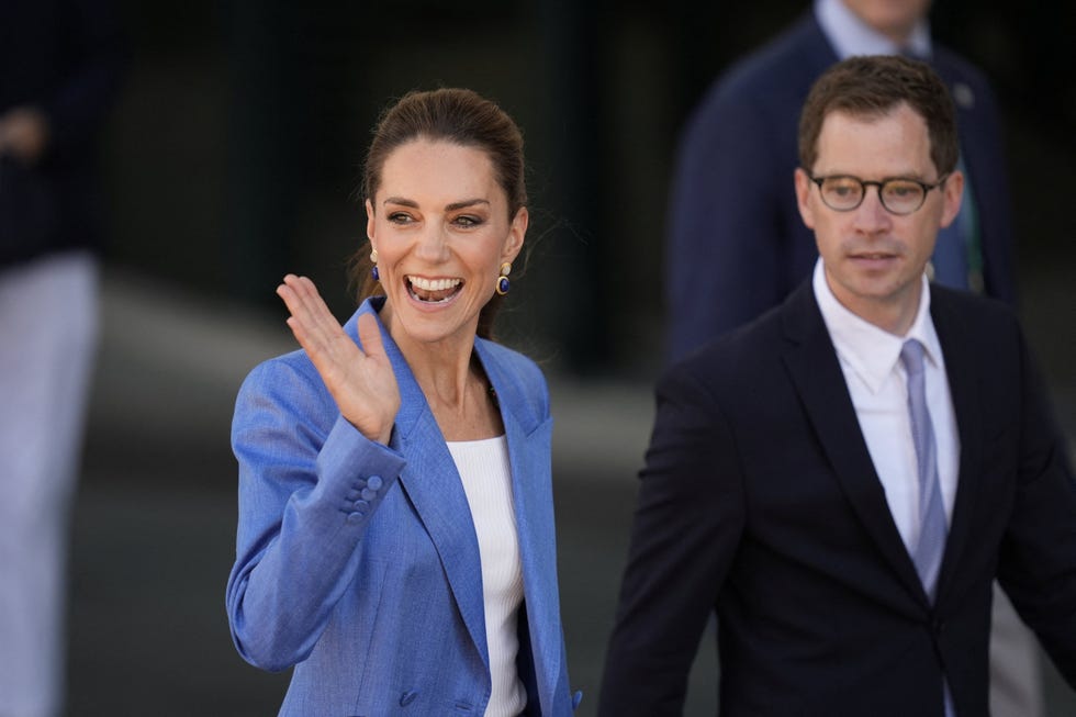 TENNIS-GBR-WIMBLEDON-ROYALS britains catherine, princess of wales (l) waves to the spectators as she walks through the grounds on the fourth day of the 2026 wimbledon championships at the all england lawn tennis and croquet club in wimbledon, southwest london, on july 2, 2026. (photo by andrew matthews / pool / afp via getty images) / restricted to editorial use no commercial use without prior written consent of the aeltc. just still image use no moving images to emulate broadcast. no superimposing or removal of sponsor/ad logos.