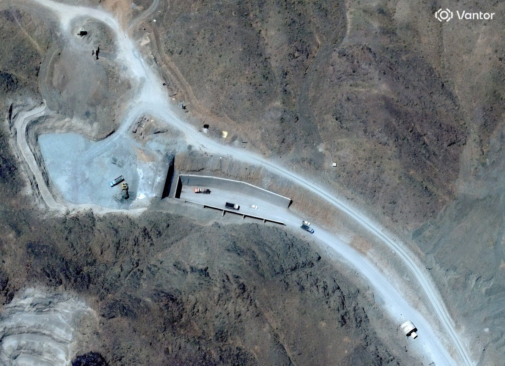 A satellite view shows vehicles at an entrance to Pickaxe Mountain tunnels, of the of the Natanz nuclear facility, near Natanz, Iran, June 21, 2026.