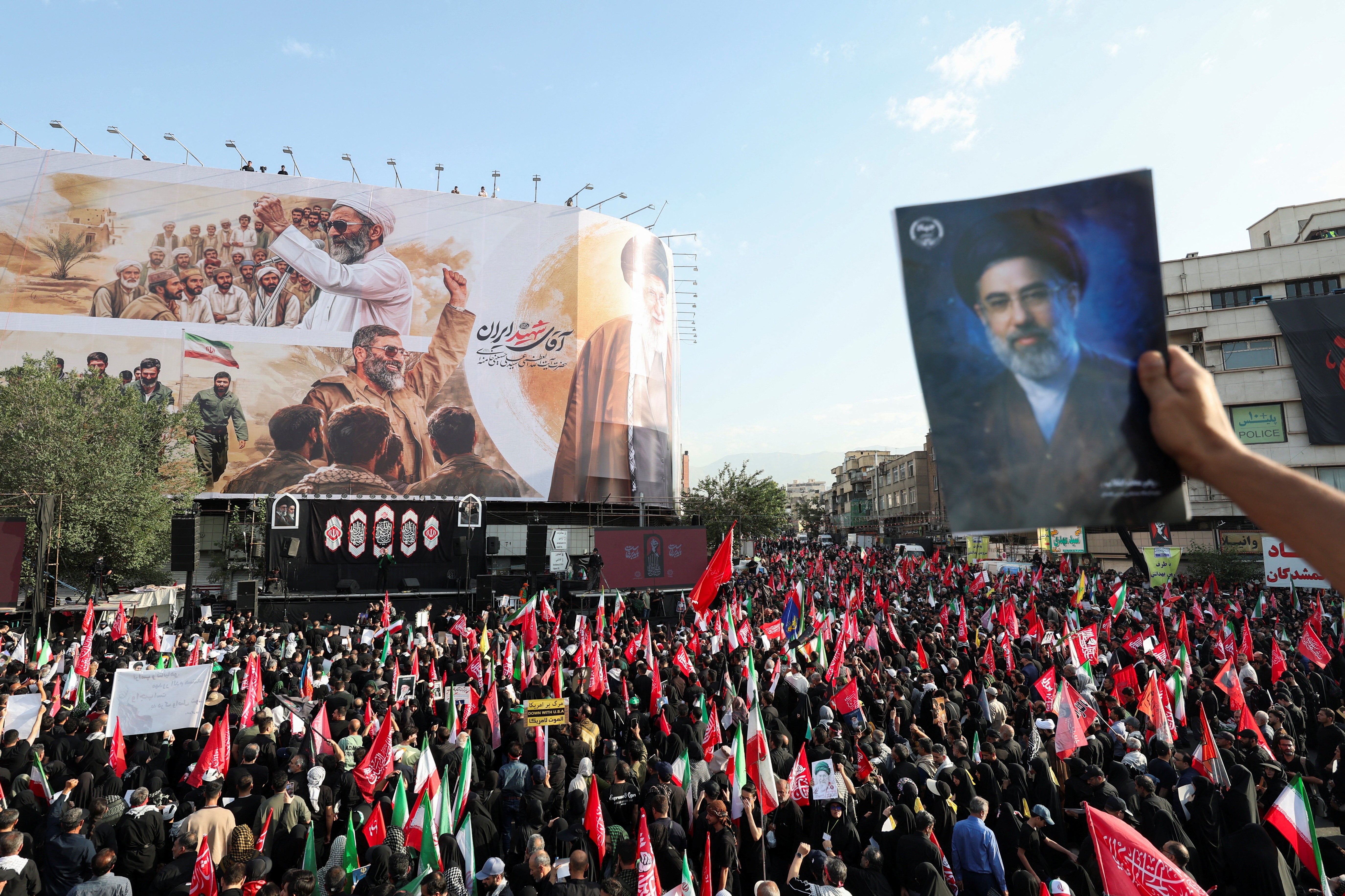 A mourner holds an image of Iran's Supreme Leader Mojtaba Khamenei as people gather for a funeral procession for Iran's late Supreme Leader Ayatollah Ali Khamenei