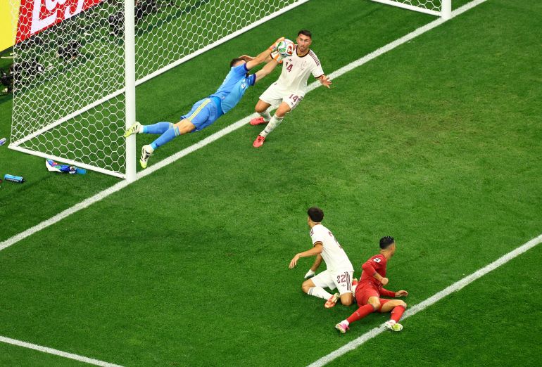 Spain's Unai Simon saves a shot on goal by Portugal's Cristiano Ronaldo