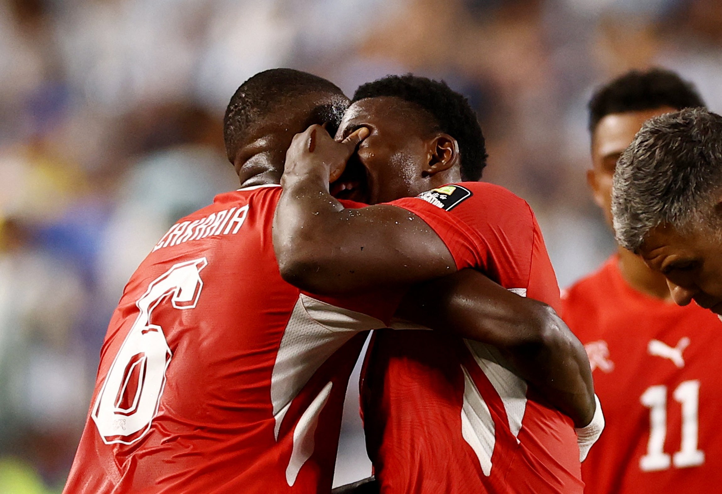 Switzerland's Denis Zakaria consoles Breel Embolo with after he is shown a second yellow card and red card