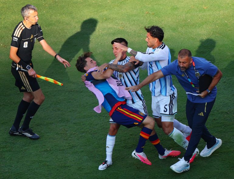 Argentina's Leandro Paredes and Thiago Almada clash with Spain's Gavi after the match