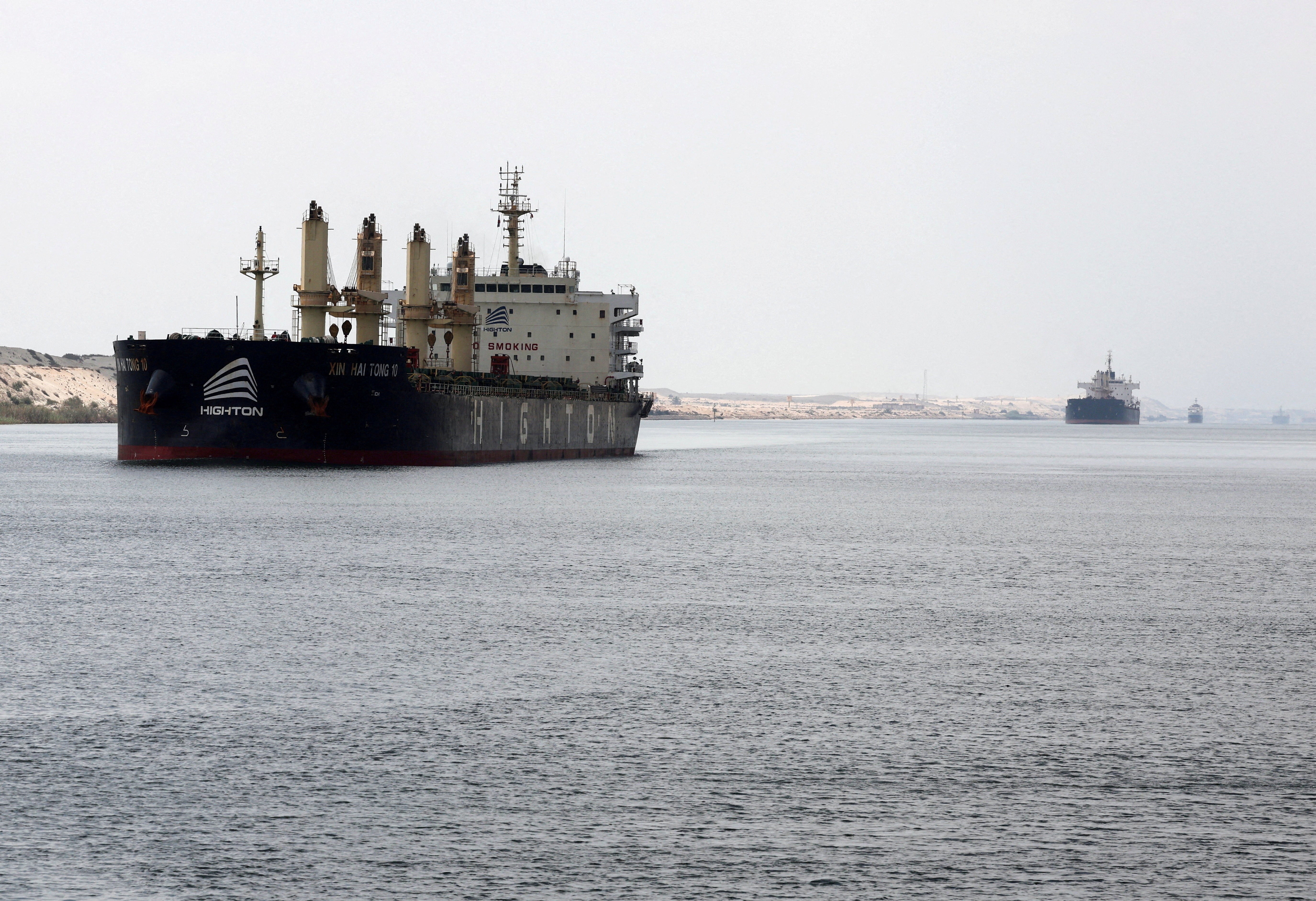 File: Ships move through the Suez Canal, in Ismalia, Egypt, 31 July 2025