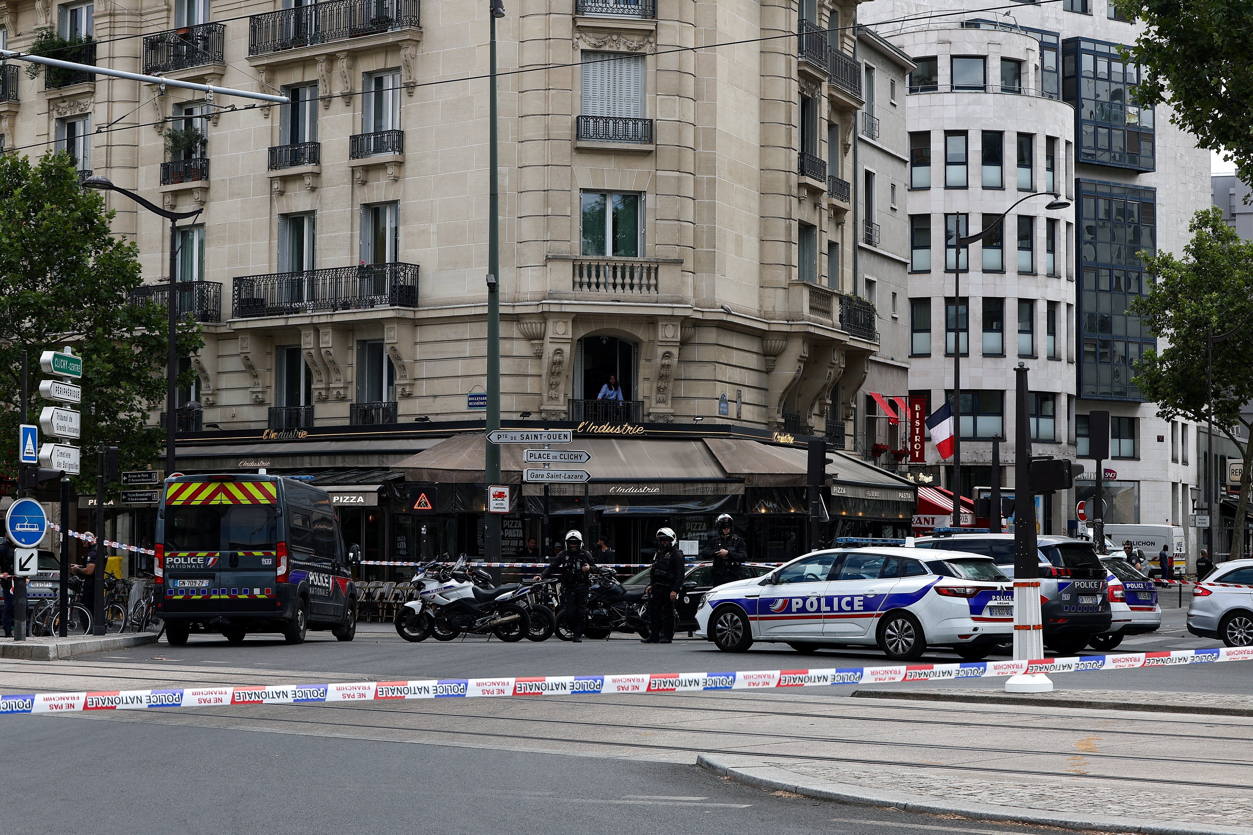 Police stand guard after a knife attack near the Porte de Clichy in Paris
