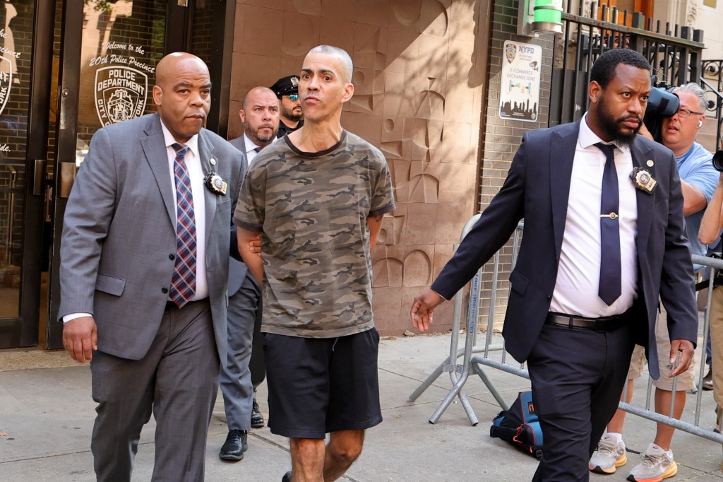 Detectives escort Raul Morales, in a camouflage shirt, following his arrest in connection with two stabbing attacks.