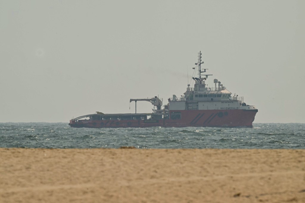A ship sails in the water off the coast of Ajman.