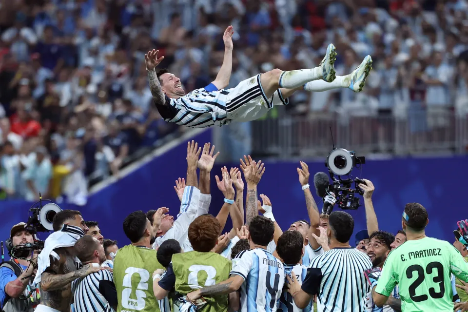 Lionel Messi is thrown in the air by team-mates after Argentina beat Egypt