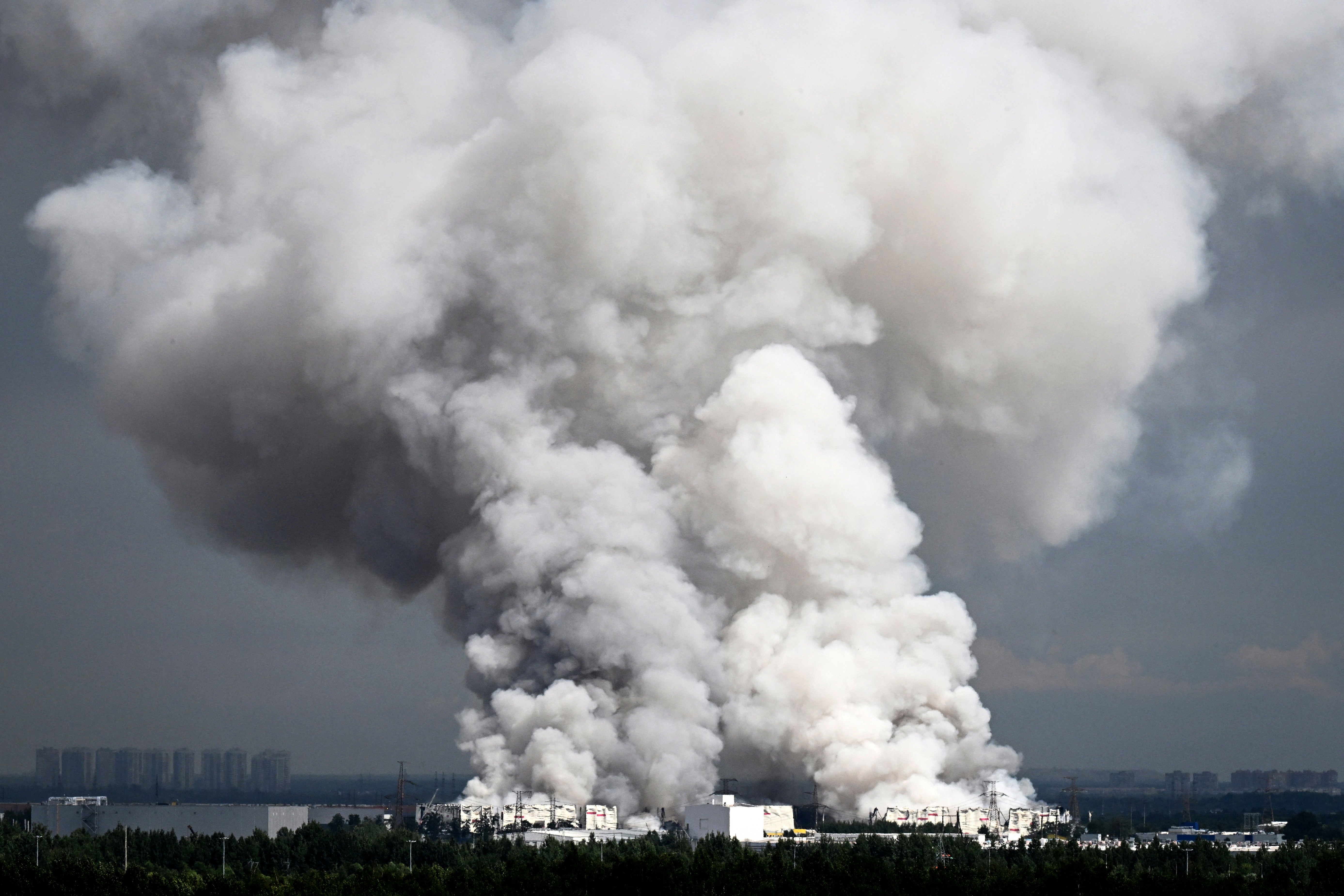 Smoke rises from a warehouse for a Russian e-commerce giant near Saint Petersburg after being hit by Ukrainian drones early on 24 July 2026