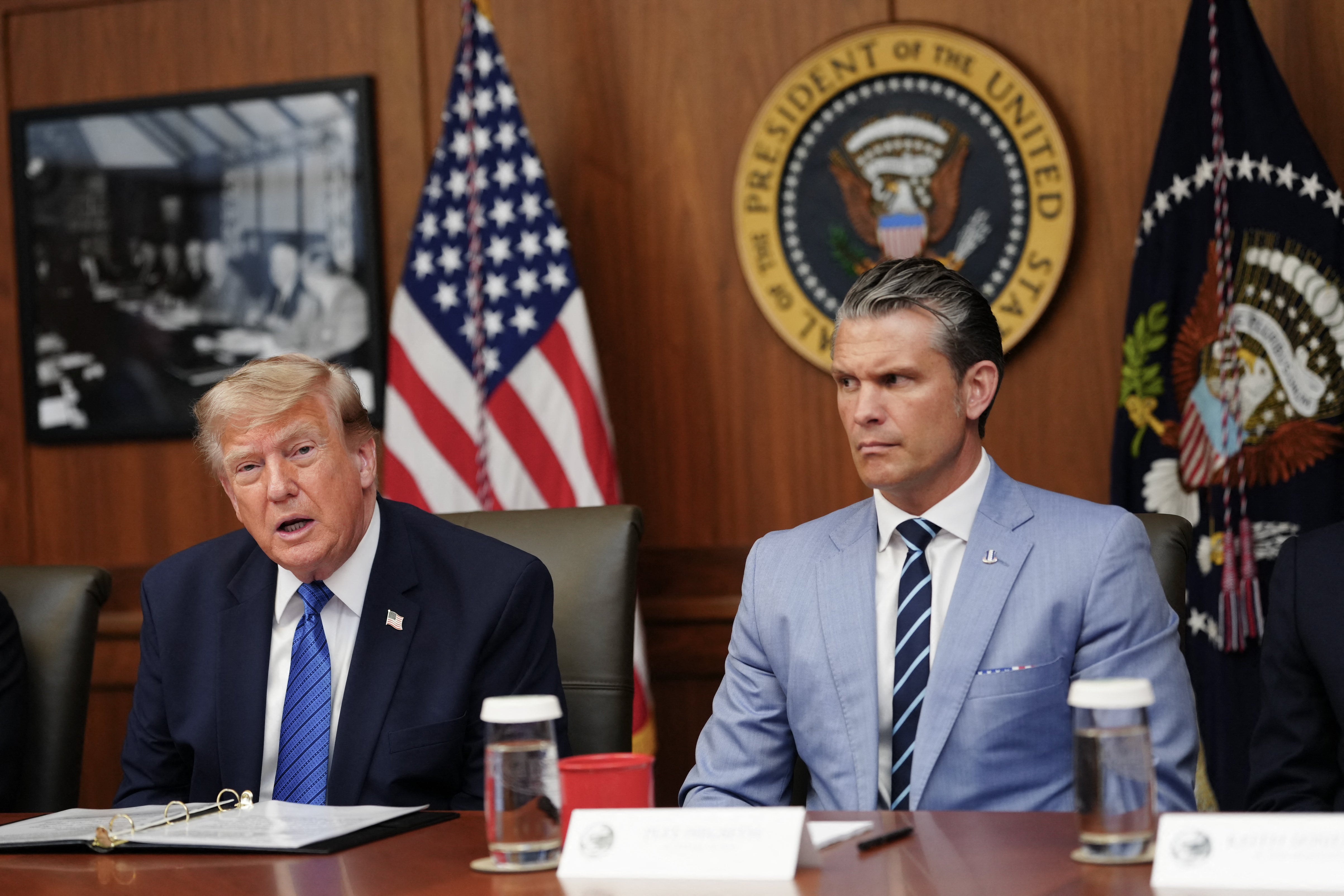 President Donald Trump speaks about thwarted Iranian missile strikes alongside Secretary of Defense Pete Hegseth during a Cabinet meeting at Camp David Friday