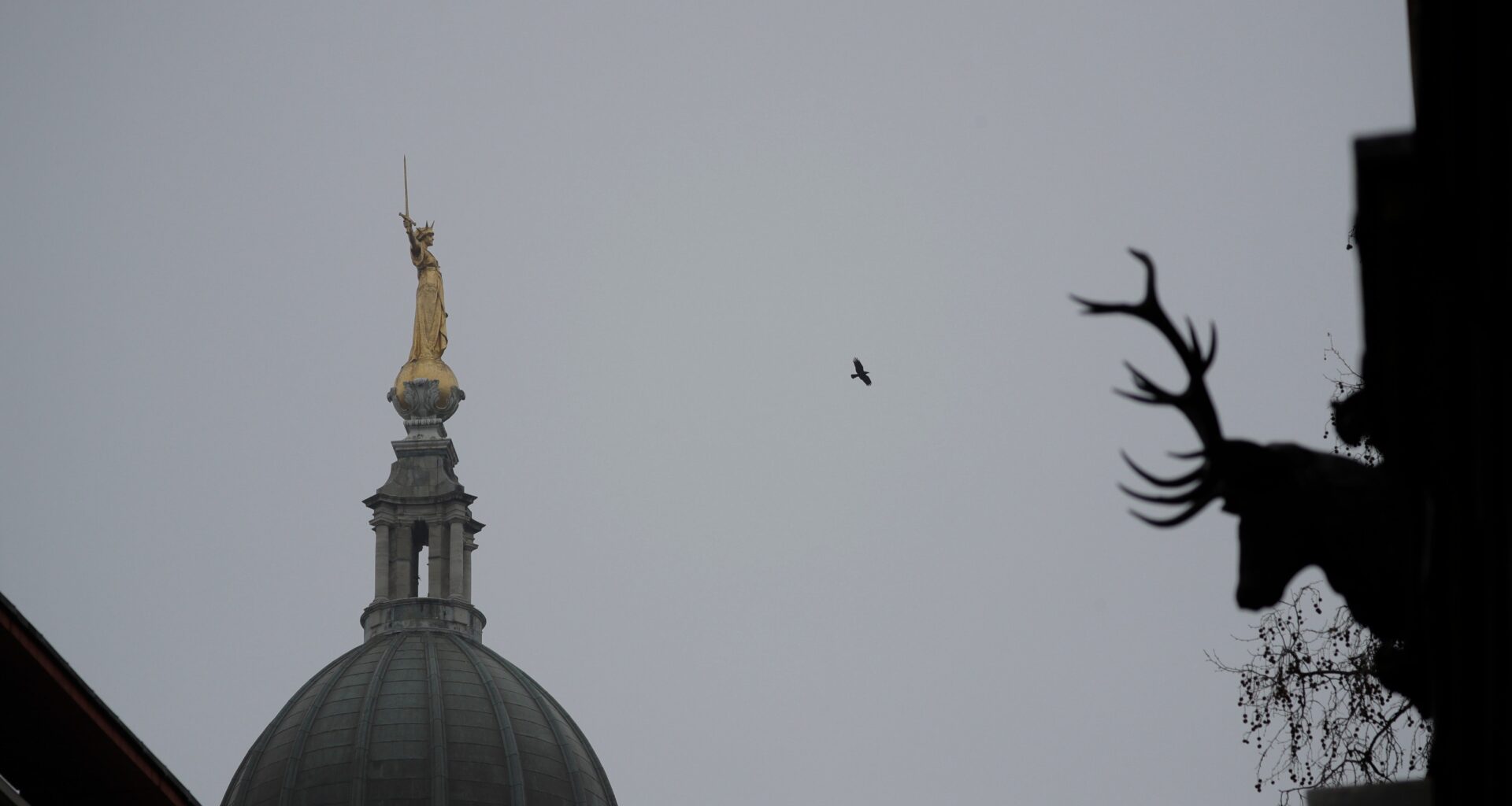 FILE - The statue of Lady Justice stands on top of the Old Bailey court in morning mist in London, March 3, 2021. (AP Photo/Matt Dunham, File)
