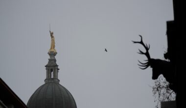 FILE - The statue of Lady Justice stands on top of the Old Bailey court in morning mist in London, March 3, 2021. (AP Photo/Matt Dunham, File)