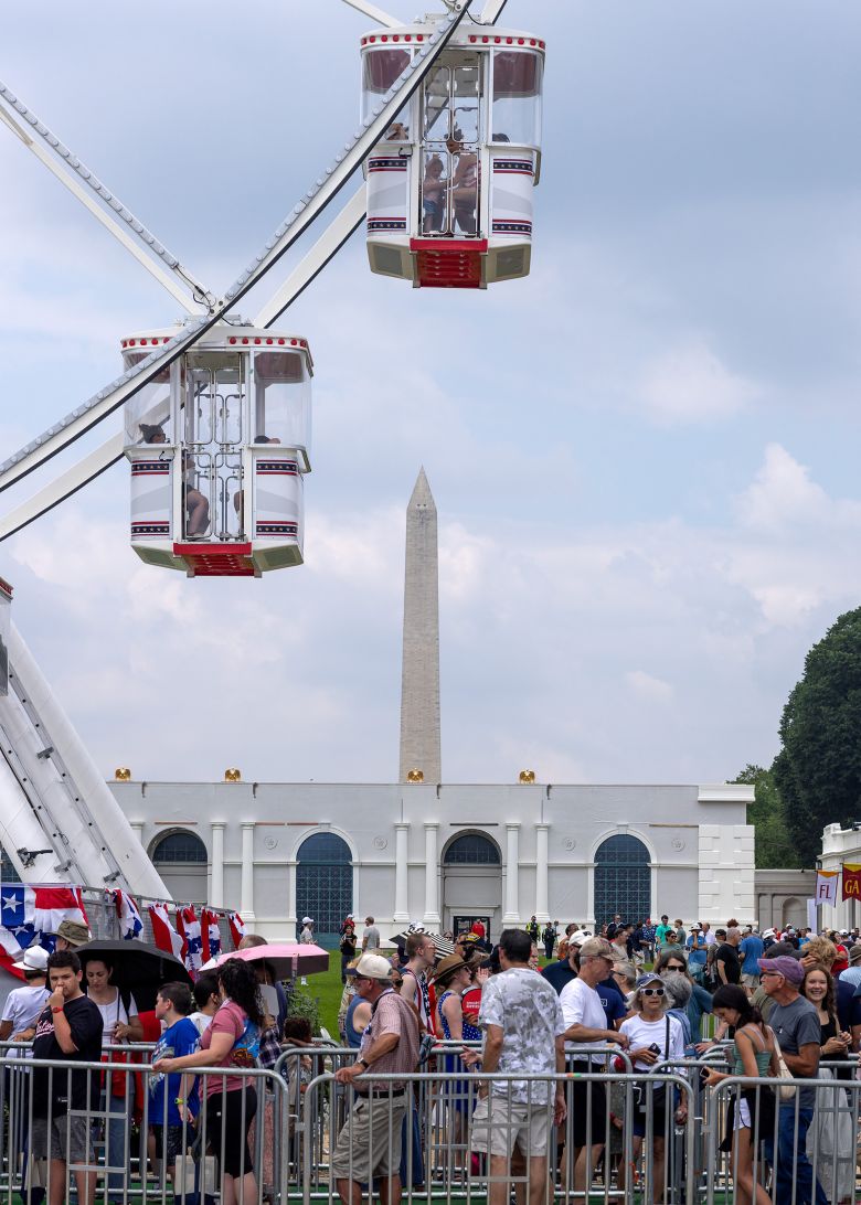 People wait to board the ferris wheel at the Great American State Fair.