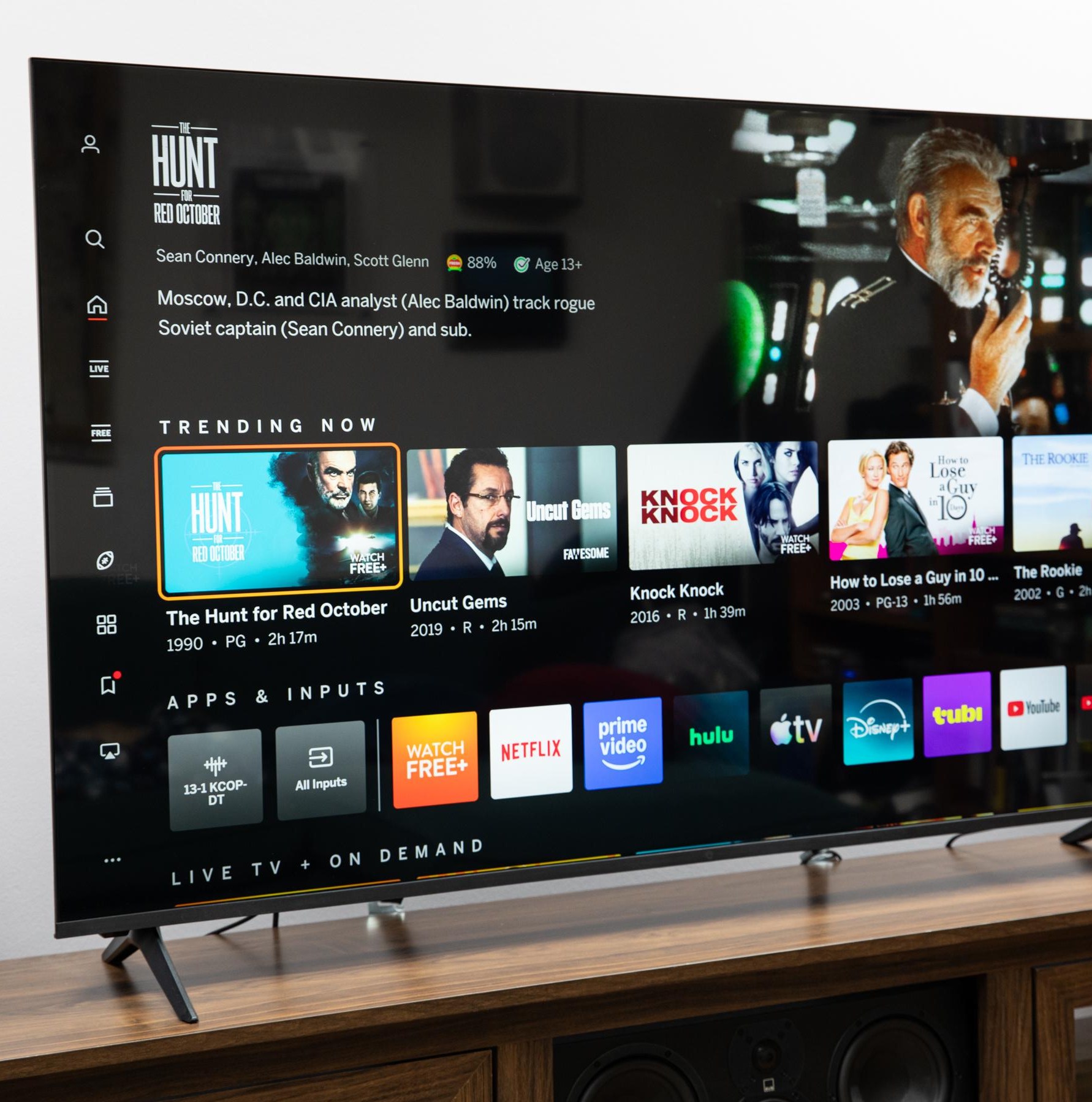 The Vizio Mini LED Quantum display the Vizio OS home page, on a wooden credenza.