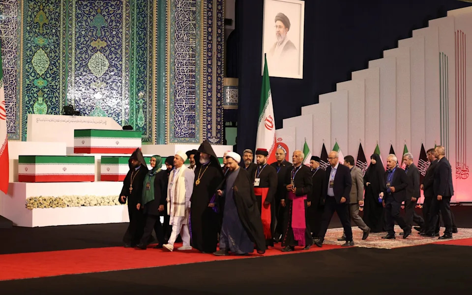 Religious leaders pay their respects alongside the coffin of Ali Khamenei and those of a number of other people killed alongside him in an air strike on his home on the first day of the war