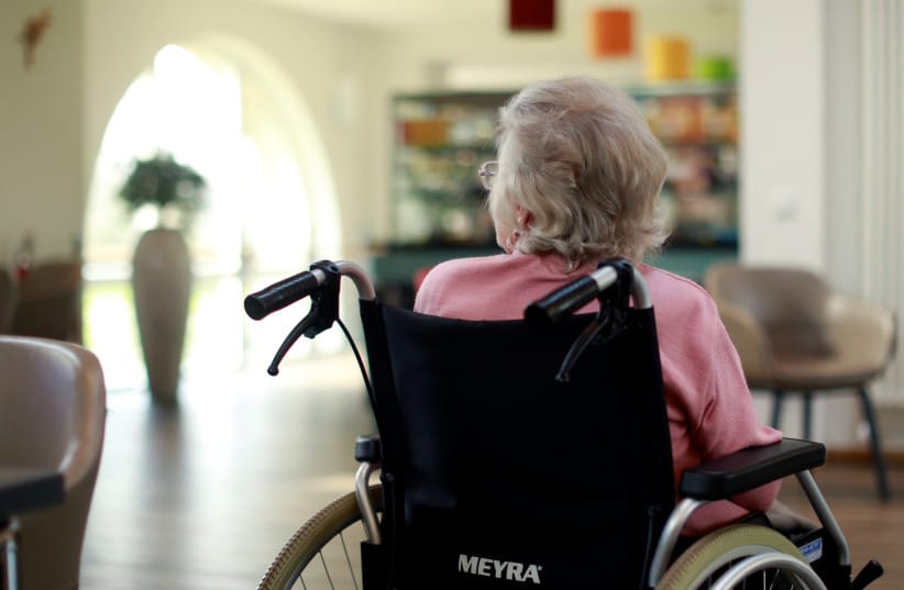 Illustrative: An elderly woman sits in the recreation room of a retirement home as visits have been restricted due to the coronavirus disease (COVID-19) concerns in Grevenbroich