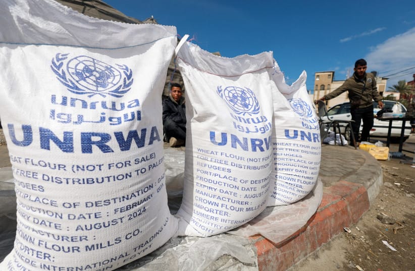 Displaced Palestinians wait to receive United Nations Relief and Works Agency (UNRWA) aid, amid the ongoing conflict between Israel and the Palestinian Islamist group Hamas, in Rafah, in the southern Gaza Strip, March 7, 2024.