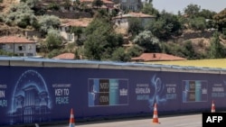 Billboards reading 'Key to Peace,' 'Key to Security,' and 'Shared Future in Peace' line a street ahead of the NATO summit in Ankara, set for July 7-8.