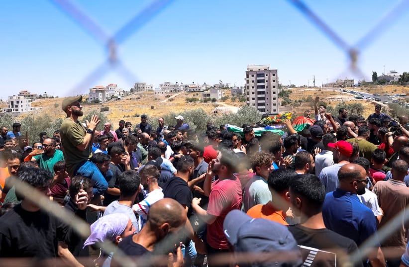  Mourners carry the bodies of Mohammad al-Shalabi, 23, and Sayafollah Musallet, 20, during their funeral in Al-Mazra'a ash-Sharqiya, east of Ramallah in the West Bank, July 13, 2025. (credit: Mohammad Nazal / Middle East Images via AFP via JTA)