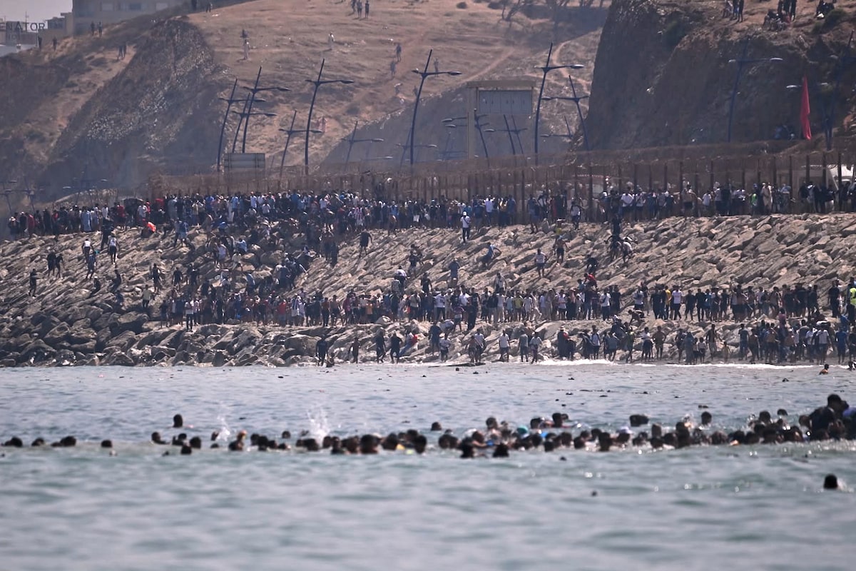 Spain deploys military to Ceuta as thousands cross border from Morocco and at least nine die