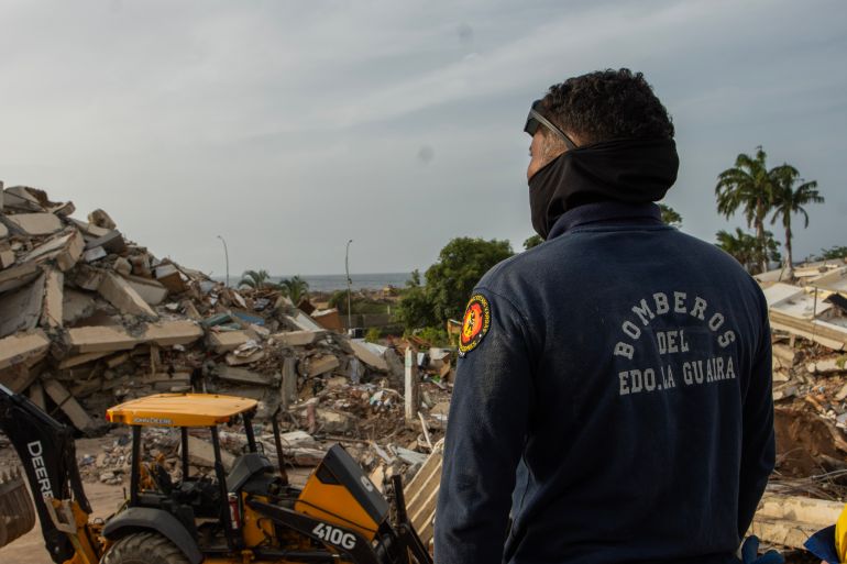 Jesus Garcia looks at the remains of the Ritasol Palace apartment complex