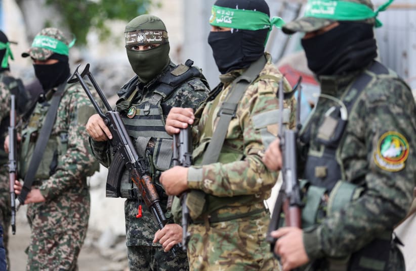 Gunmen stand guard at the funeral of Marwan Issa, a senior Hamas deputy military commander who was killed in an Israeli airstrike during the conflict between Israel and Hamas, amid a ceasefire between Israel and Hamas, in the central Gaza Strip, February 7, 2025.
