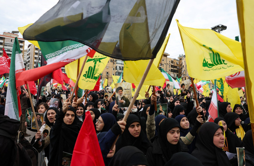 Protesters raise Hezbollah and Iranian flags, after the late Iranian Supreme Leader Ayatollah Ali Khamenei was killed in Israeli and US strikes on Iran, during a rally in solidarity with the Iranian regime, in Beirut, Lebanon, March 1, 2026.