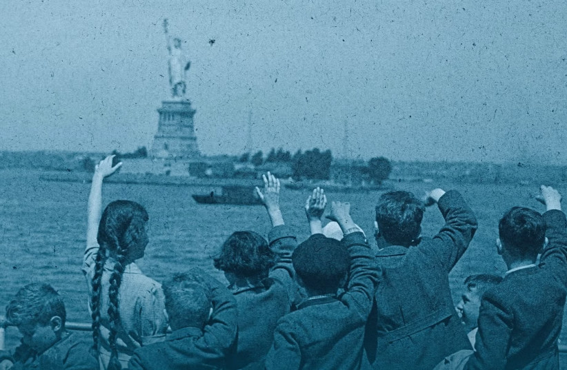 A group of young Austrian immigrants wave to the Statue of Liberty upon their arrival in America aboard the S.S. Harding. The 50 Jewish children, who were greeted by their new adoptive families, were fleeing Nazi persecution in their homeland. (credit: