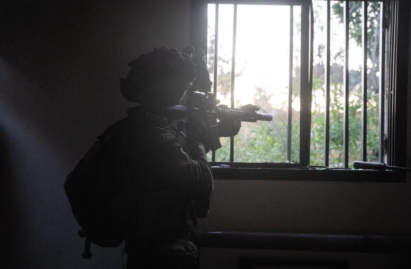 (ILLUSTRATIVE) AN IDF soldier aiming out of a window in southern Lebanon.