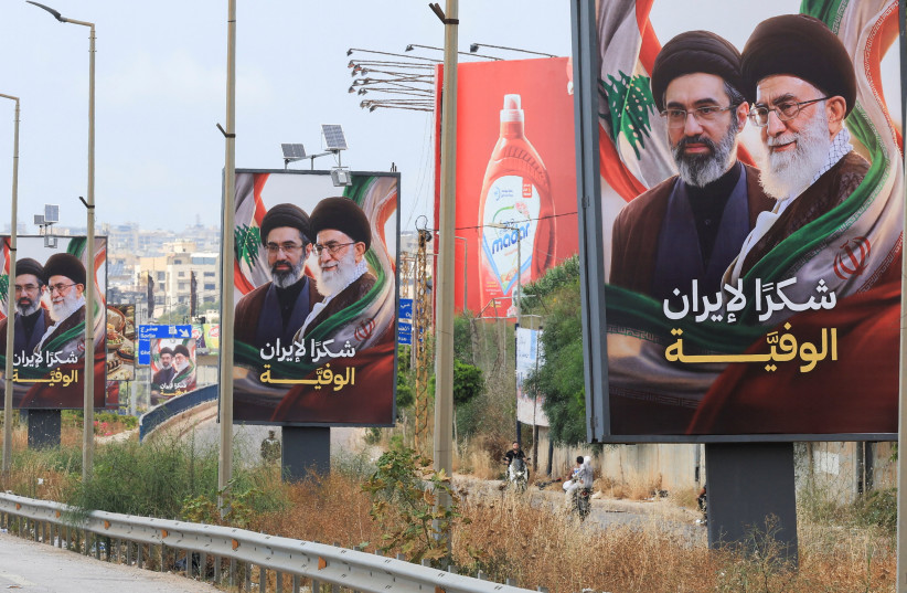 Vehicles drive past billboards showing Iran’s Supreme Leader Ayatollah Mojtaba Khamenei and his late father, with the slogan “Thank you to loyal Iran” erected along the highway leading to Rafic Hariri International Airport in Beirut, Lebanon, June 22, 2026