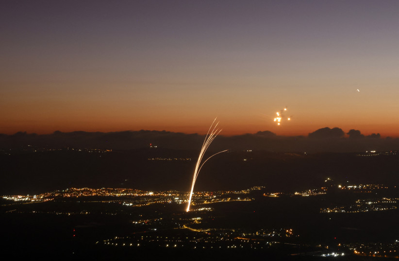 Rockets fired from southern Lebanon are intercepted by Israel's Iron Dome air defence system over the Upper Galilee region in northern Israel on August 23, 2024.
