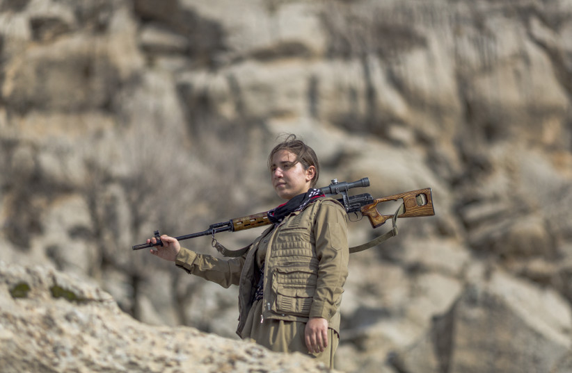 A member of the Kurdistan Democratic Party of Iran (KDPI) participates in a military drill in an outpost near Erbil, Kurdistan region of Iraq on January 15, 2026.