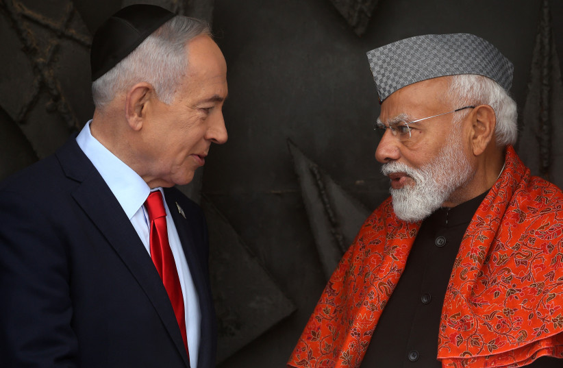 India's Prime Minister Narendra Modi (R) speaks with his Israeli counterpart Benjamin Netanyahu after paying respect before the eternal flame at the Hall of Remembrance during his visit to the Yad Vashem Holocaust Memorial Museum in Jerusalem on February 26, 2026.