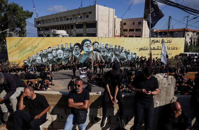 A flag depicting late former Hezbollah leader Hassan Nasrallah flutters as Shi'ite mourners mark Ashura, in the southern suburbs of Beirut, Lebanon, June 26, 2026