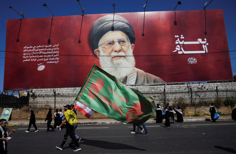 Shi'ite mourners walk past a banner depicting Iran's late Supreme leader Ayatollah Ali Khamenei as they mark Ashura, the holiest day on the Shi'ite Muslim calendar, in the southern suburbs of Beirut, Lebanon, June 26, 2026.