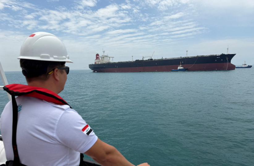 A sailor observes the oil tanker HELGA, which is moored at one of Iraq's southern offshore oil terminals near Basra, as it prepares to load crude oil, becoming the second vessel to arrive since the closure of the Strait of Hormuz, April 24, 2026.