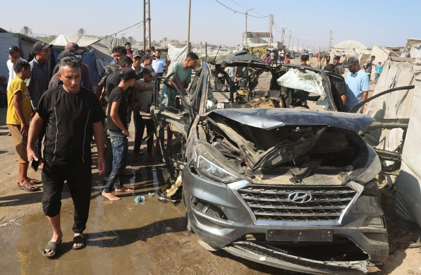 Palestinians inspect the site of an Israeli strike on a vehicle in Khan Younis, in the southern Gaza Strip, July 6, 2026.