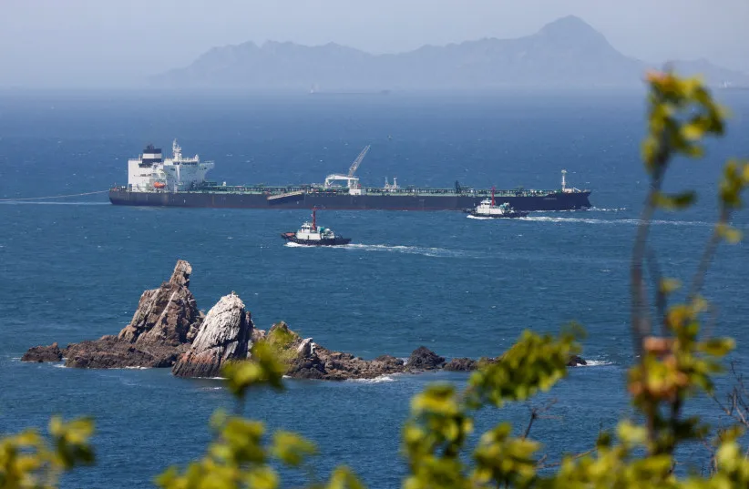 Tugboats guide the crude oil tanker Odessa, carrying UAE crude after passing through the Strait of Hormuz with its Automatic Identification System transponder turned off, navigates the waters at Daesan port, where it is expected to discharge crude oil, in Seosan, South Korea, May 8, 2026.
