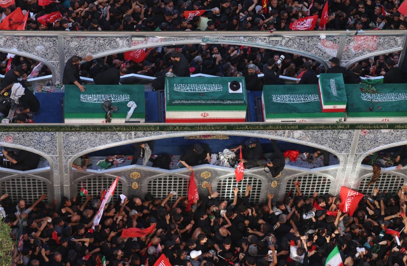 Crowds of mourners surround the convoy carrying the coffins of Iran's slain supreme leader Ali Khamenei during a funeral procession, in Mashhad, July 9, 2026